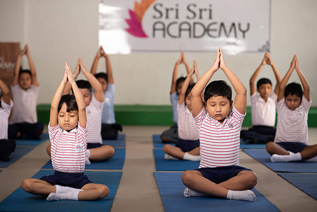 Sri Sri Academy students practising yoga together