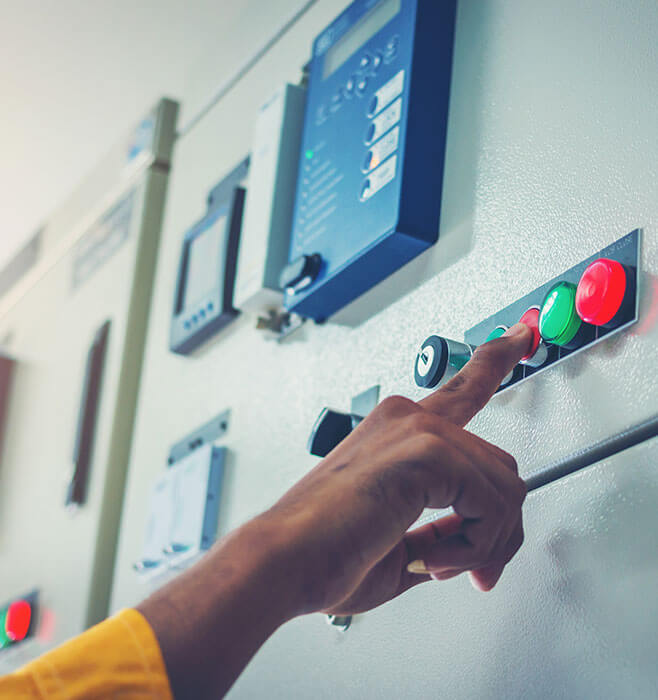 Engineer operating a power control panel