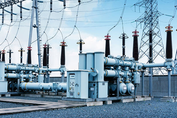 High-voltage substation equipment against a blue sky