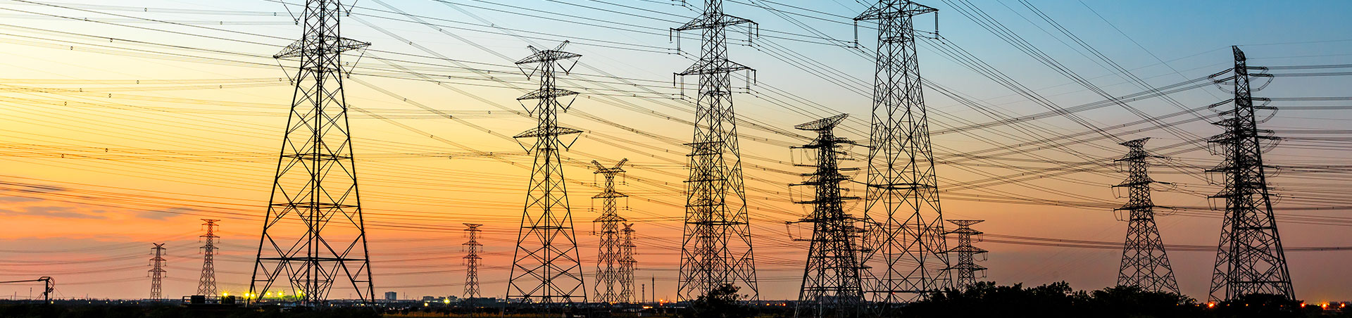 Power transmission towers and conductors at sunset