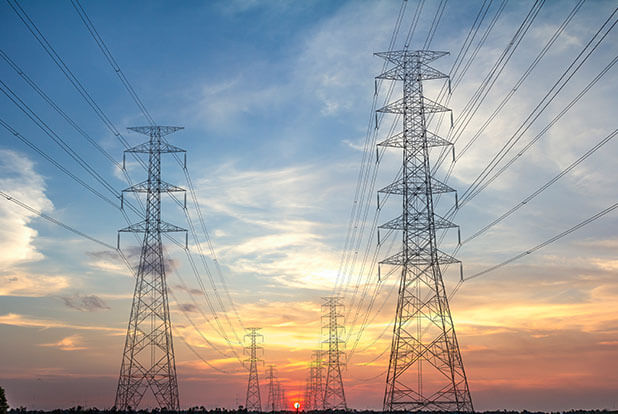 Transmission towers and overhead conductors at dusk